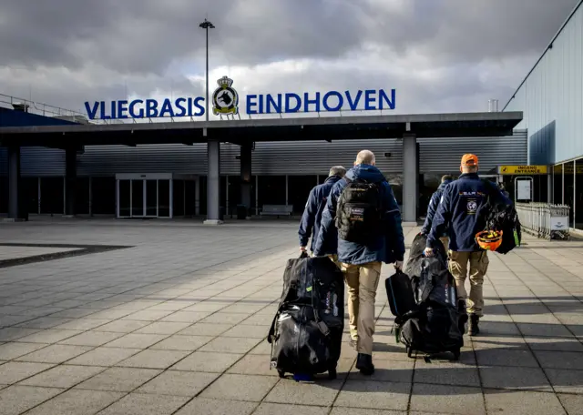 Members of the Dutch search and rescue team USAR arrive at Eindhoven Air Base, the Netherlands