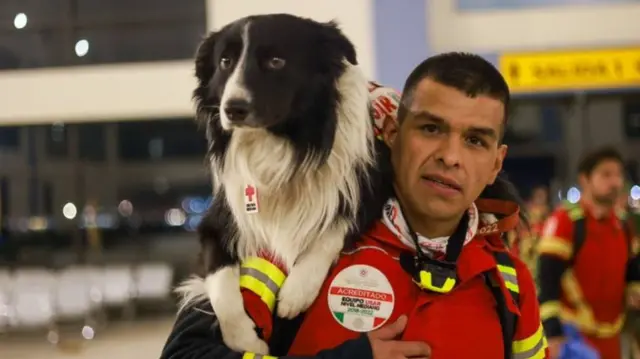 A member of one of Mexico's urban search and rescue teams with his dog