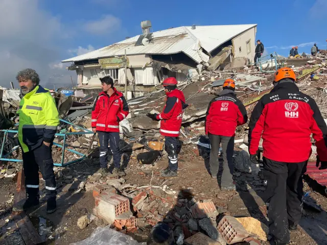 Search and rescue team search through the debris