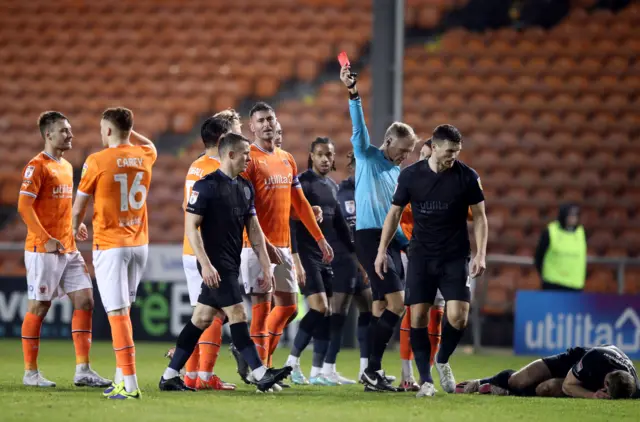 Gary Madine is shown a red card