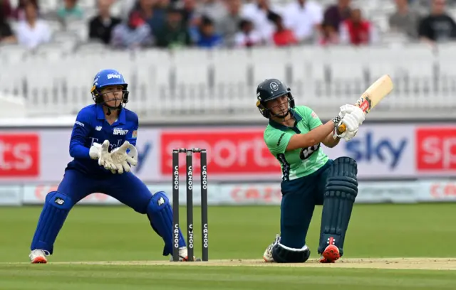 Alice Capsey hits a shot while playing for Oval Invincibles against London Spirit in the inaugural season of The Hundred in 2021