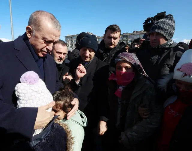 Turkish President Recep Erdogan hugs two children while visiting the city of Kahramanmaras in the aftermath of the February 2023 earthquake