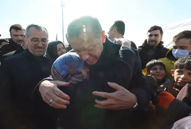 Turkish President Recep Erdogan hugs a woman while visiting the city of Kahramanmaras in the aftermath of the February 2023 earthquake