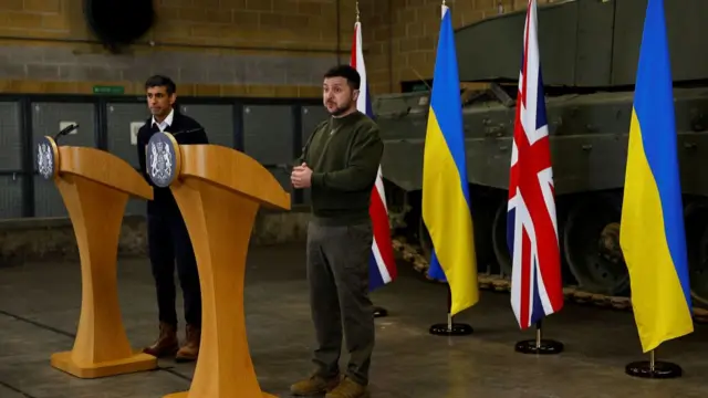 Zelensky and Sunak stand at lecterns