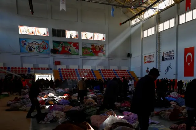 Bodies covered in blankets in a stadium in Kahramanmaras, Turkey