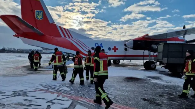 Rescuers of the State Emergency of Ukraine board a plane, on their way to help find survivors of the deadly earthquake in Turkey, at an unknown location in Ukraine February 7, 2023. Press service of the Interior Ministry of Ukraine/Handout