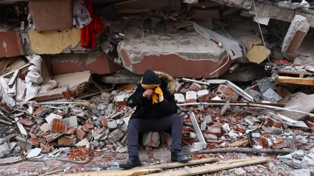 A man reacts at the site of a collapsed building in the aftermath of a major earthquake in the Elbistan district of Kahramanmaras, Turkey, 08 February 2023.