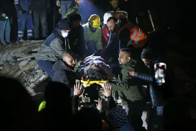 A man is pulled from the rubble in Hatay, Turkey