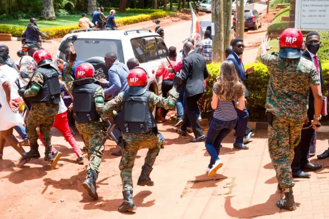 Supporters of Uganda opposition leader Robert Kyagulanyi, also known as Bobi Wine, and local and foreign journalists are assaulted by Uganda Military Police outside the UN Human RIghts offices on February 17, 2021.