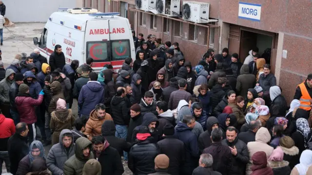 A crowd outside a morgue in Diyarbakir, Turkey,