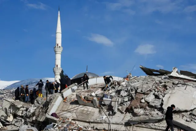 Rescuers work at the site of a damaged building in the aftermath of the deadly earthquake in Kahramanmaras, Turkey