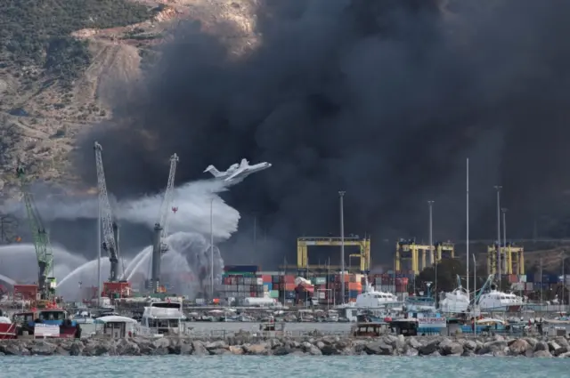 A plane drops water over the blaze at Iskenderun port on Tuesday