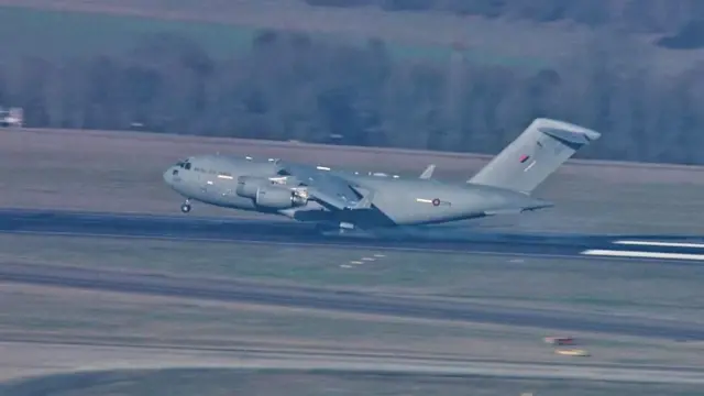 Military plane landing on runway