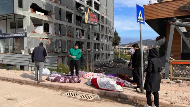 Covered dead bodies on the street of Antakya.