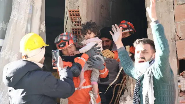 Members of a South Korean disaster relief team rescue a toddler in Antakya, Hatay province, Turkey, 09 February 2023,