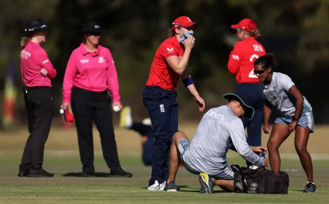 England captain Heather Knight receives treatment after being hit in the face by a shot by South Africa's Nadine de Klerk in a Women's T20 World Cup warm-up