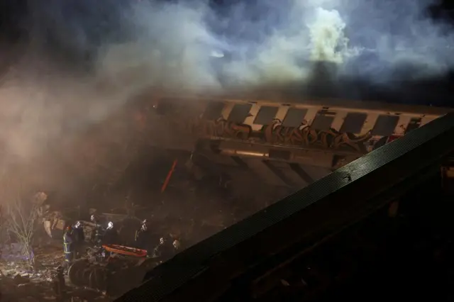 Firefighters operate at the site of a crash, where two trains collided, near the city of Larissa, Greece, March 1, 2023.