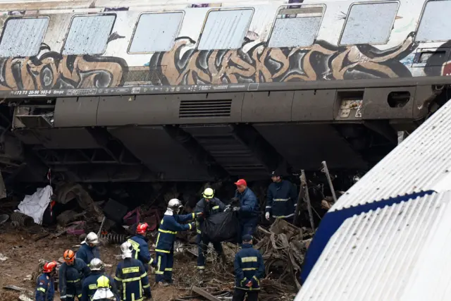 Rescuers work at the scene of the train collision