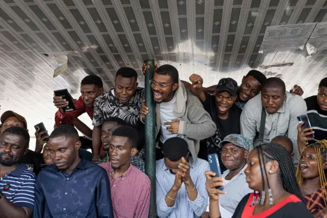 Voters react during vote counting at Nnamdi Azikiwe University polling station in Awka on 25 February 2023, during Nigeria's presidential and general election