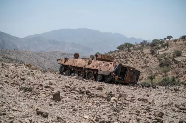 A destroyed tank stands next to a road near the village of Erebti, 400 kilometers of Semera, Ethiopia, on June 8, 2022