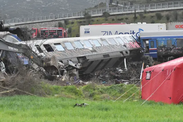 A wrecked rail carriage off its tracks