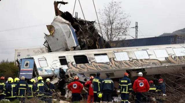 Rescuers work at the scene of the train collision