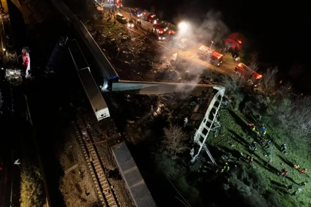 A picture taken with a drone shows firefighters and rescue crews working to extricate passengers from trains after a collision near Larissa city, Greece, 01 March 2023.