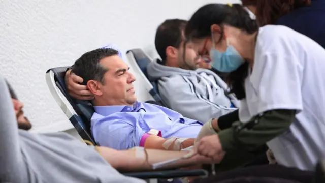 Greek opposition leader Alexis Tsipras gives blood to help those injured in the train crash