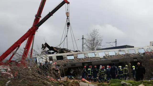 Shot of emergency workers with cranes at the site of a train crash in Greece