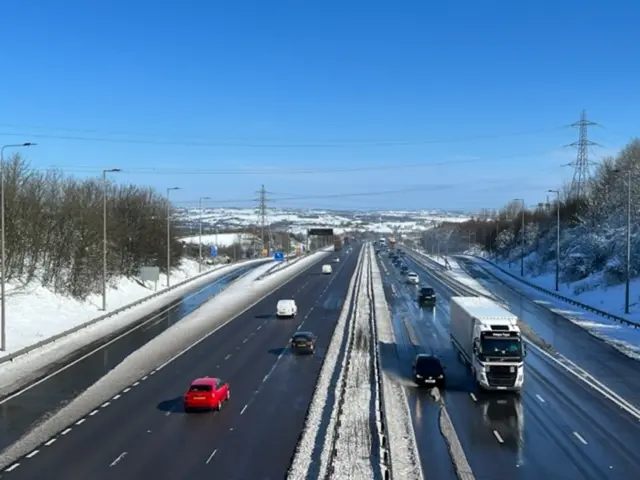 Traffic flowing on a snowy motorway