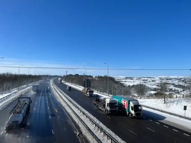 Traffic flowing on a snowy motorway