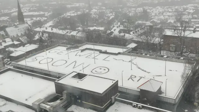 'Get well soon' wrote in snow on top of a hospital car park