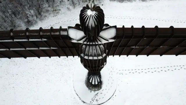 Footprints in the snow below the towering 65ft (20m) tall Angel