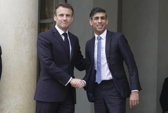 Emmanuel Macron greets Rishi Sunak at the Elysee Palace during a visit to Paris as part of the first UK-France summit in five years