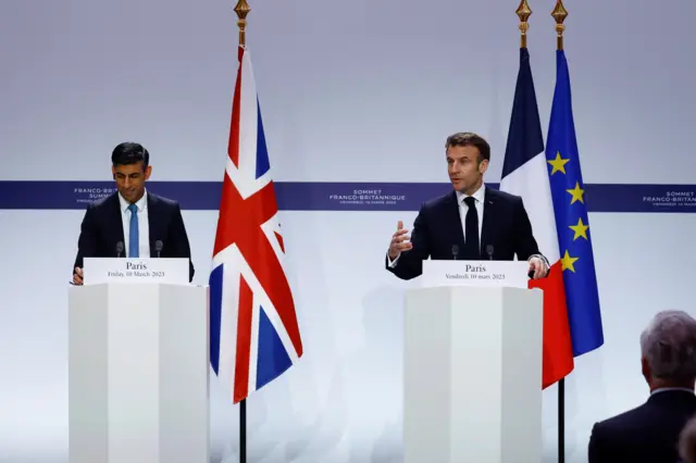 Sunak listens as Macron speaks