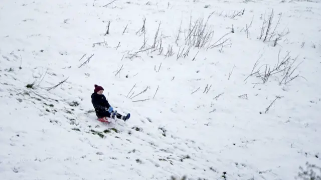 Child on toboggan