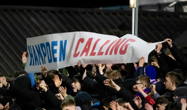 Inverness fans hold up a banner which reads 'Hampden calling'