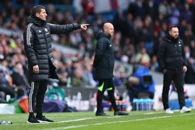 Both managers look on from the touchline