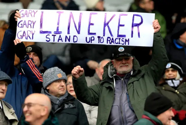 Fans at a game between Swansea City and Middlesbrough holding up a sign supporting Gary Lineker