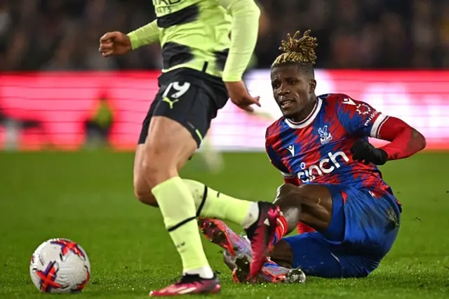 Zaha goes down after a tug from Grealish