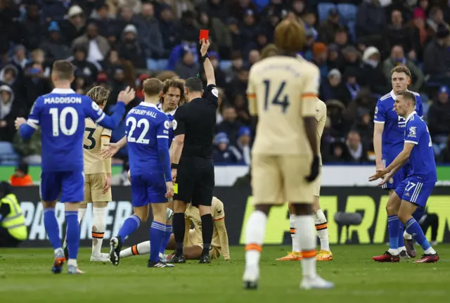 Leicester City's Wout Faes is shown a red card by referee Andre Marriner v Chelsea