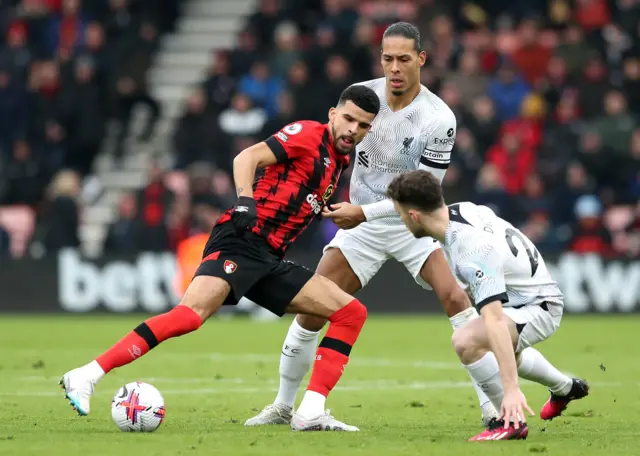 Bournemouth's Dominic Solanke (left) battles for the ball with Liverpool's Virgil van Dijk and Diogo Jota (right) during the Premier League match at the Vitality Stadium