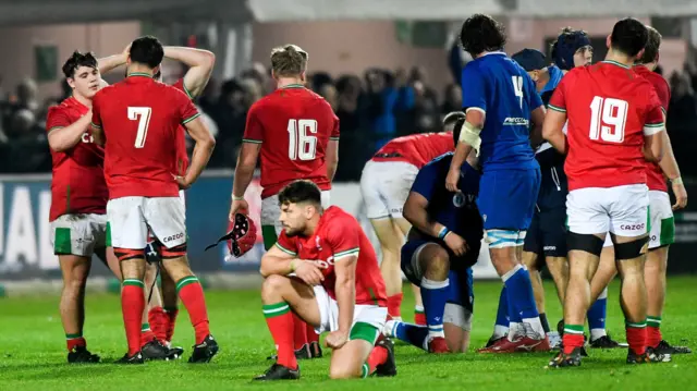 Dejected Wales under 20s players after defeat to Italy