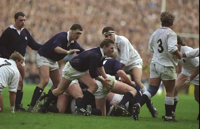 Gary Armstrong (centre) of Scotland passes the ball away from a ruck during the Five Nations Championship match against England at Murrayfield in Edinburgh, Scotland.