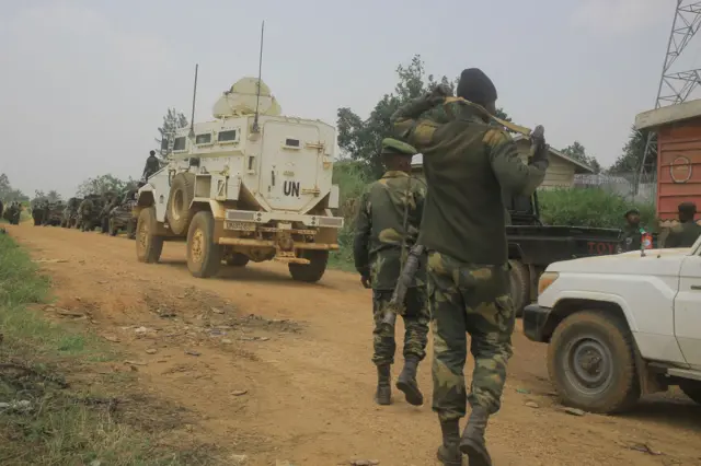 DR Congo army and UN forces escort civilian vehicles on the Beni-Komanda road near Walese Vonkutu on March 19, 2022.