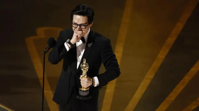 Ke Huy Quan celebrates after winning the Oscar for Actor in a Supporting Role for 'Everything Everywhere All at Once