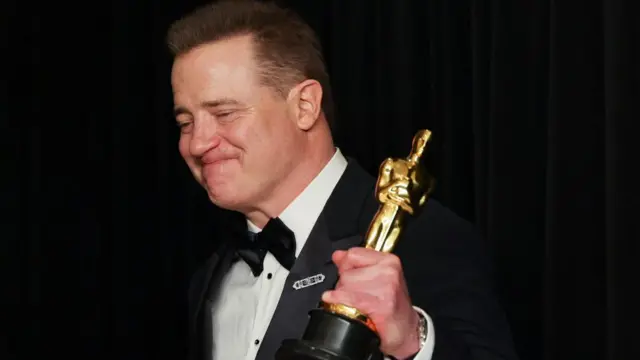 Best Actor Brendan Fraser celebrates with his Oscar backstage at the 95th Academy Awards