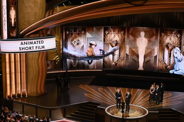 British artitst Charlie Mackesy (R) and Producer Matthew Freud (L) accept the Oscar for Best Animated Short Film for "The Boy, the Mole, the Fox and the Horse"