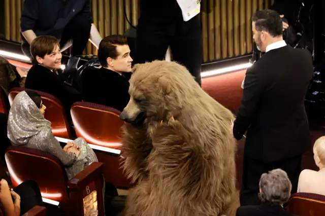 Malala Yousafzai, Cocaine Bear, and host Jimmy Kimmel speak during the 95th Annual Academy Awards