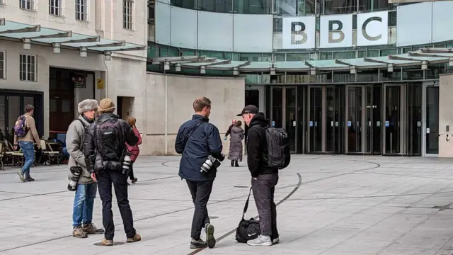 Press photographers waiting outside the BBC's New Broadcasting House in London